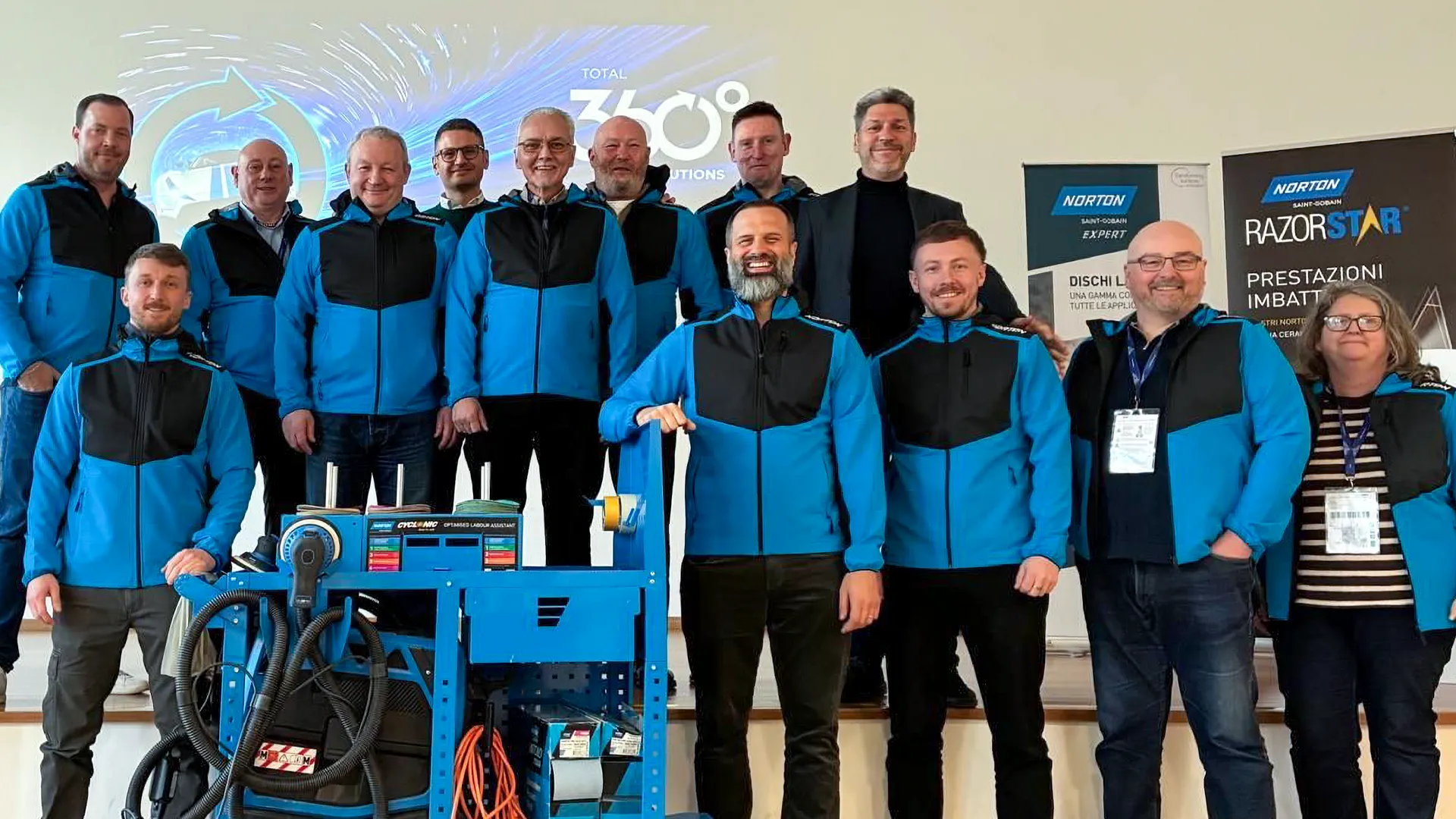 TIDAL team group photo in Norton-branded clothing during a supplier partnerships visit at the Corsico training facility in Italy